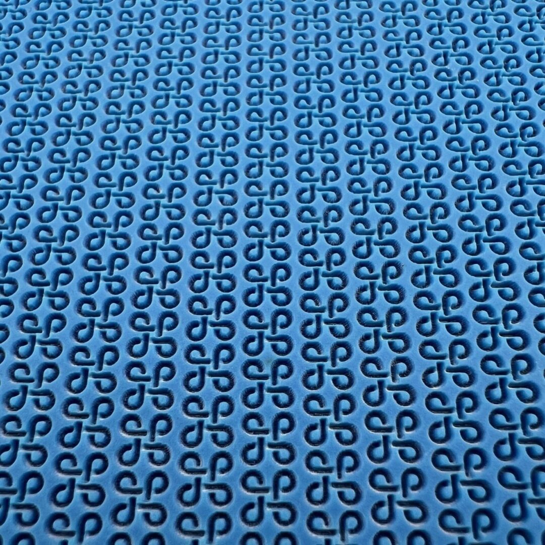 Blue fabric with repeating black abstract chain patterns.