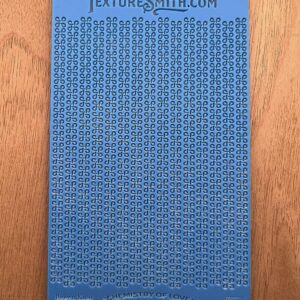 A blue textured mat with a pattern on a wooden surface.