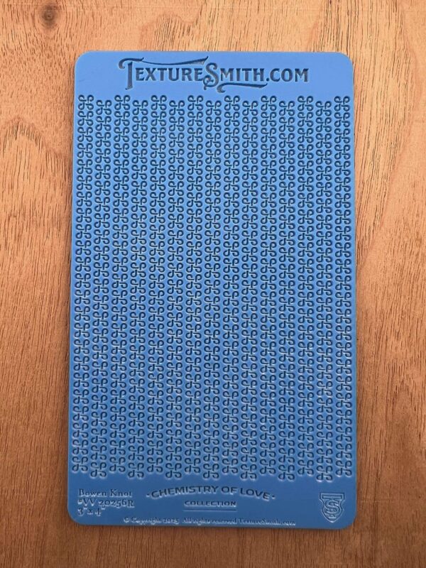 A blue textured mat with a pattern on a wooden surface.