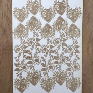 Intricate floral lace pattern in beige on white fabric.