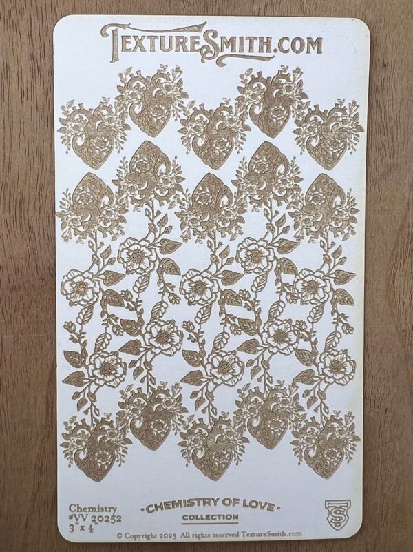 Intricate floral lace pattern in beige on white fabric.