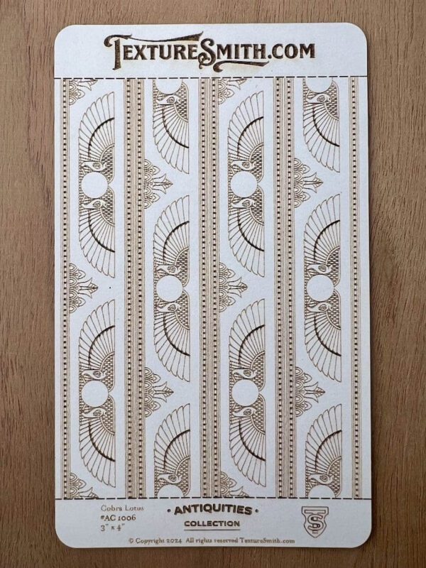 Decorative white molding strips with intricate patterns on a wooden surface.