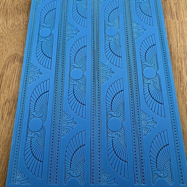 Blue mat with intricate perforated patterns and designs.