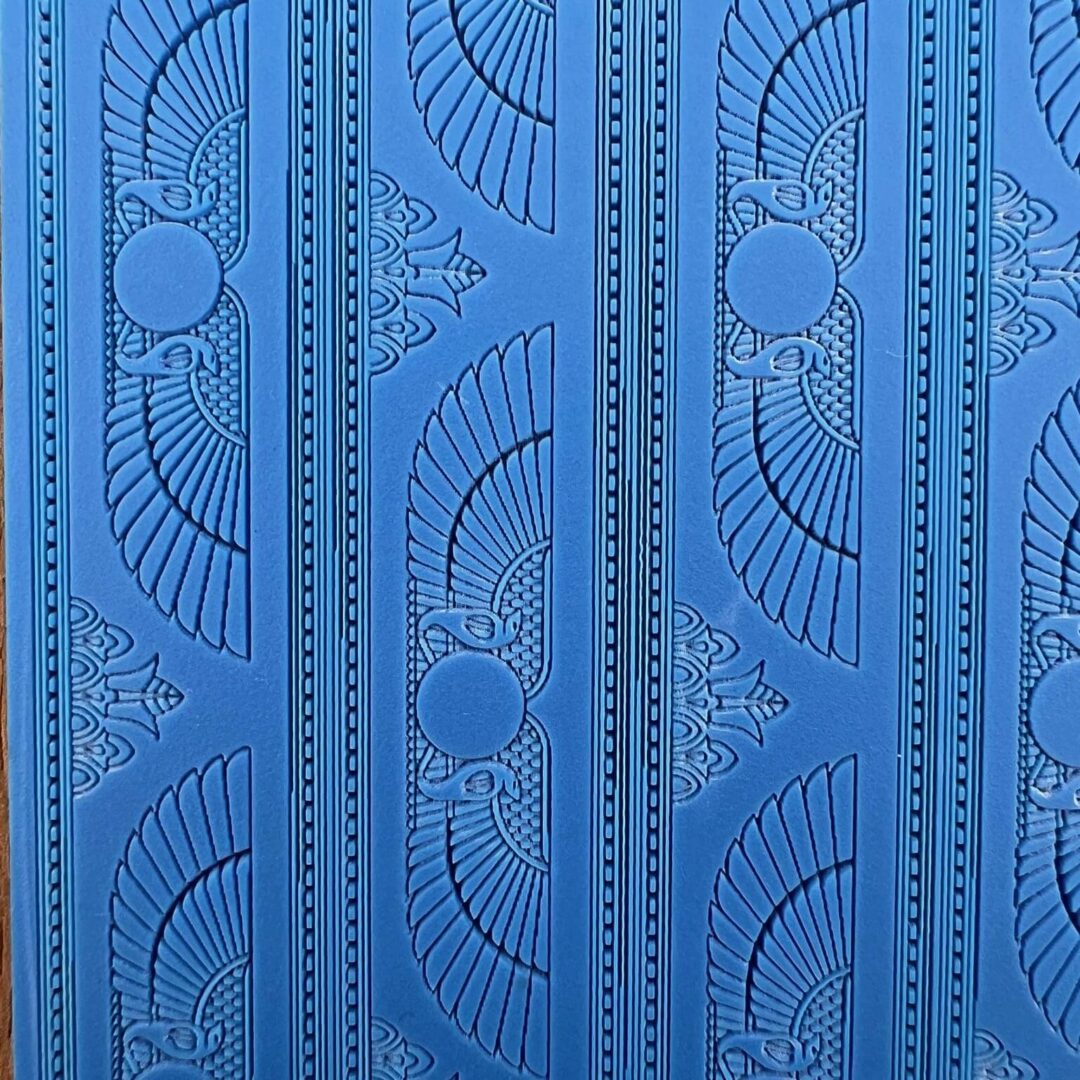 Intricate blue wall panel with geometric and circular patterns.