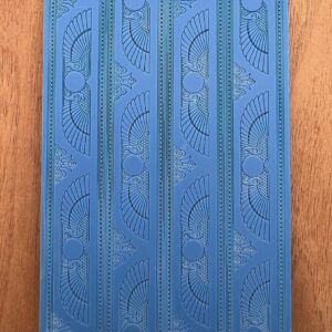 Blue patterned yoga mat with intricate design on a wooden floor.