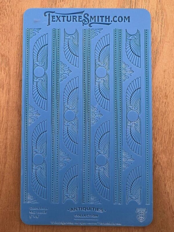 Blue patterned yoga mat with intricate design on a wooden floor.