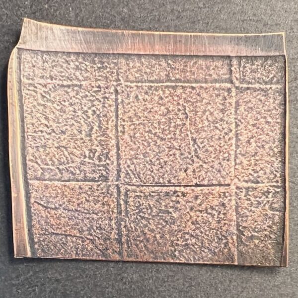 Square copper art piece with abstract textured patterns.