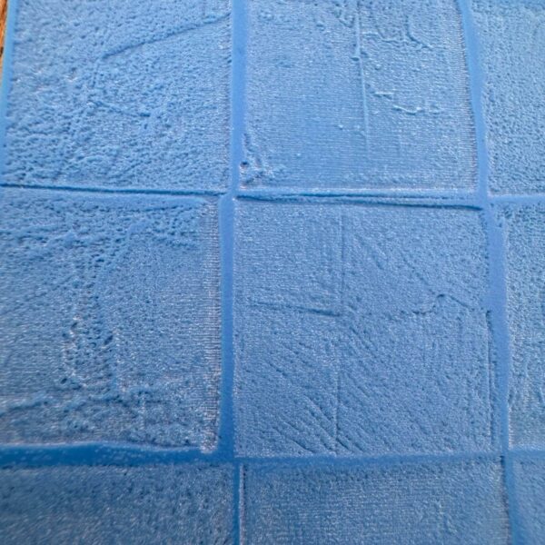 Close-up of textured blue tiles arranged in a grid pattern.