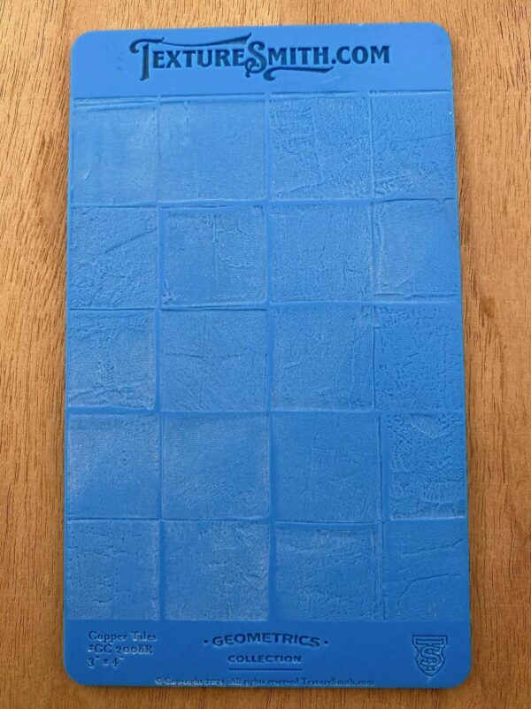 Blue textured mat with a grid pattern on a wooden surface.