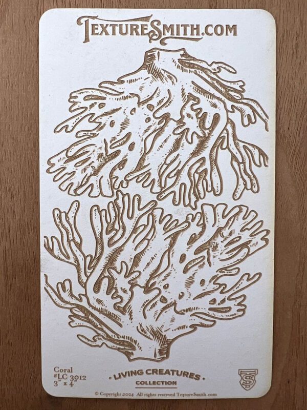 Intricate line art of coral branches on a white sheet.