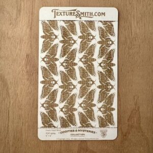 Sheet of vintage-style brown butterfly stickers on a wooden surface.