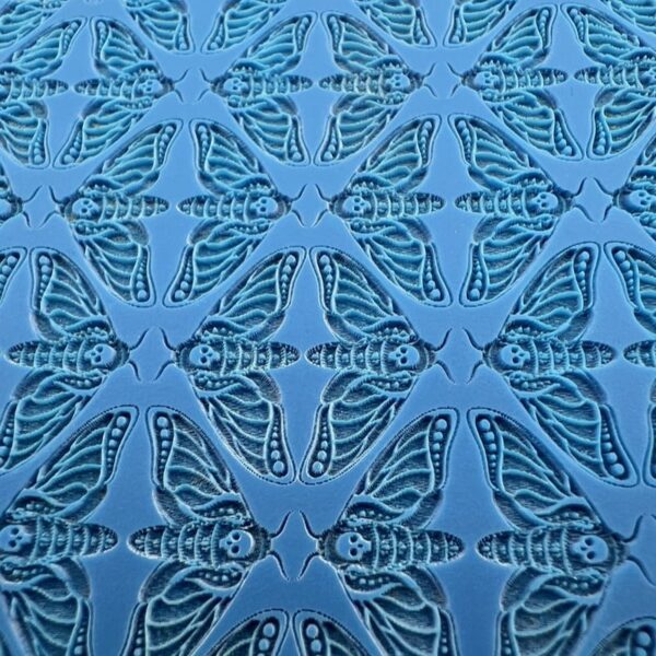 Close-up of blue patterned fabric with intricate star-like designs.