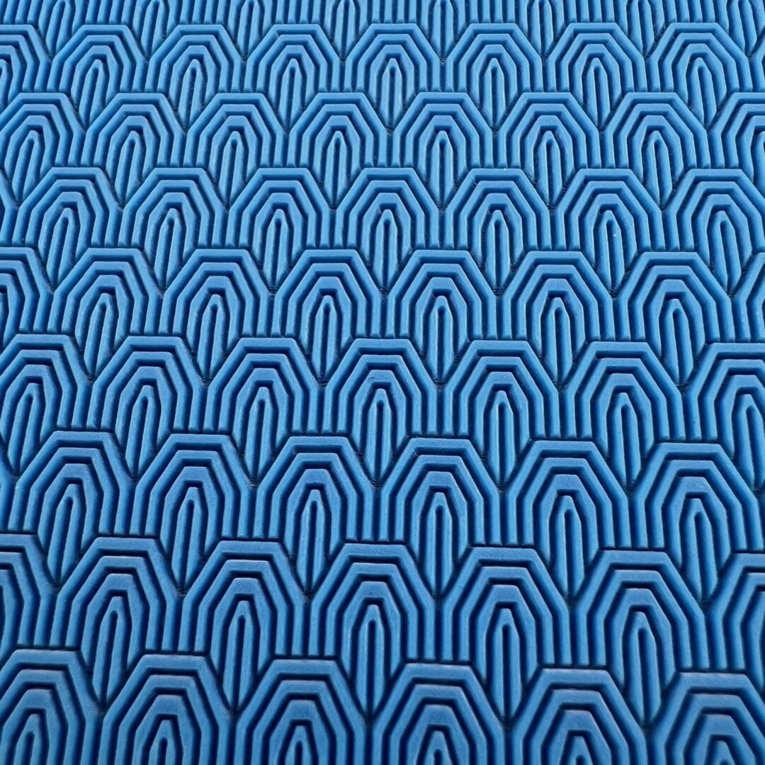 Blue fabric with a geometric pattern of concentric arches.