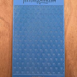 Blue textured sheet with various geometric patterns.