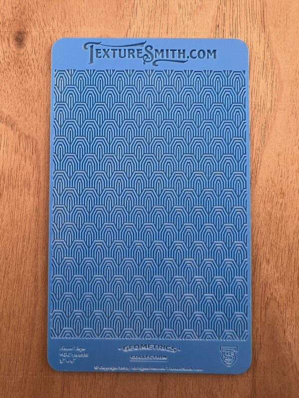 Blue textured sheet with various geometric patterns.