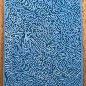 Blue artwork with intricate leaf patterns.