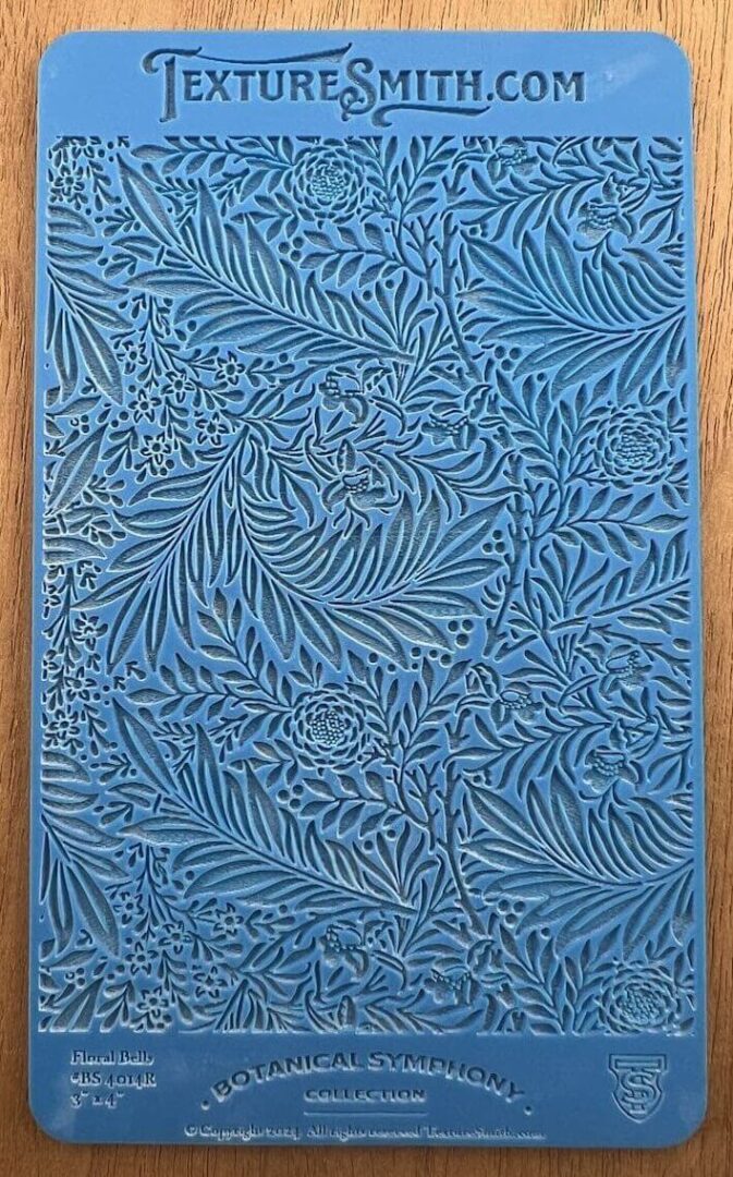 Blue artwork with intricate leaf patterns.