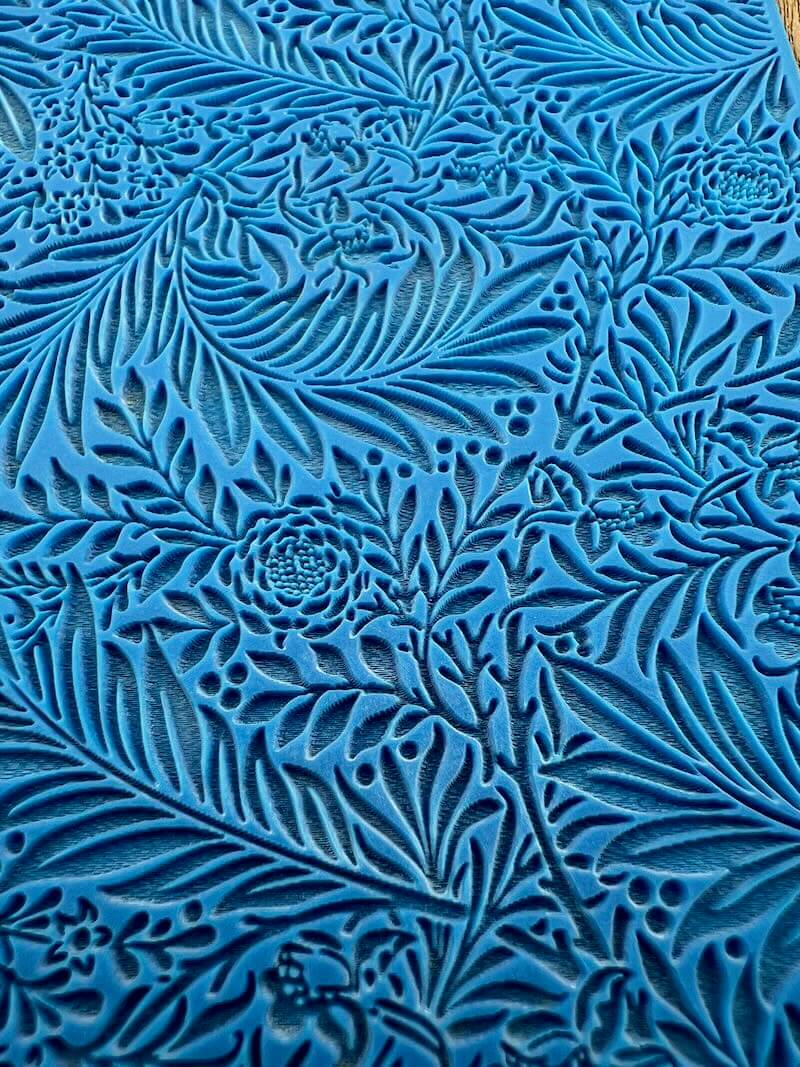 Intricate blue pattern with swirling leaf-like designs.