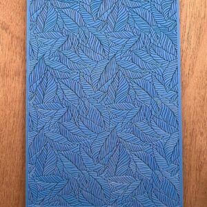 Blue textured surface with intricate leaf-like patterns.