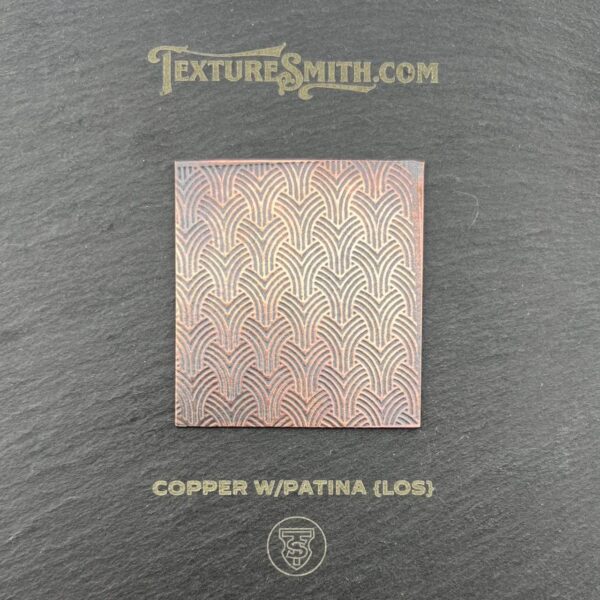 Copper patina tile sample with a textured herringbone pattern.