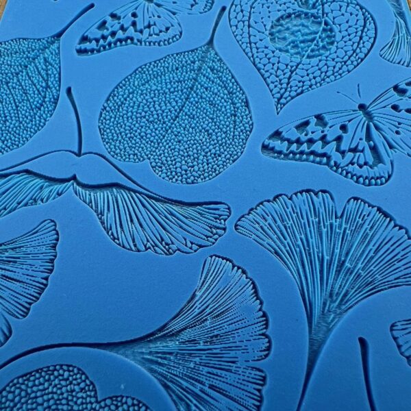 Blue background with detailed black leaf and ginkgo illustrations.