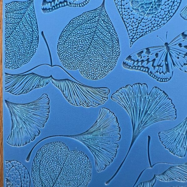 Detailed blue artwork featuring ginkgo leaves and a butterfly.