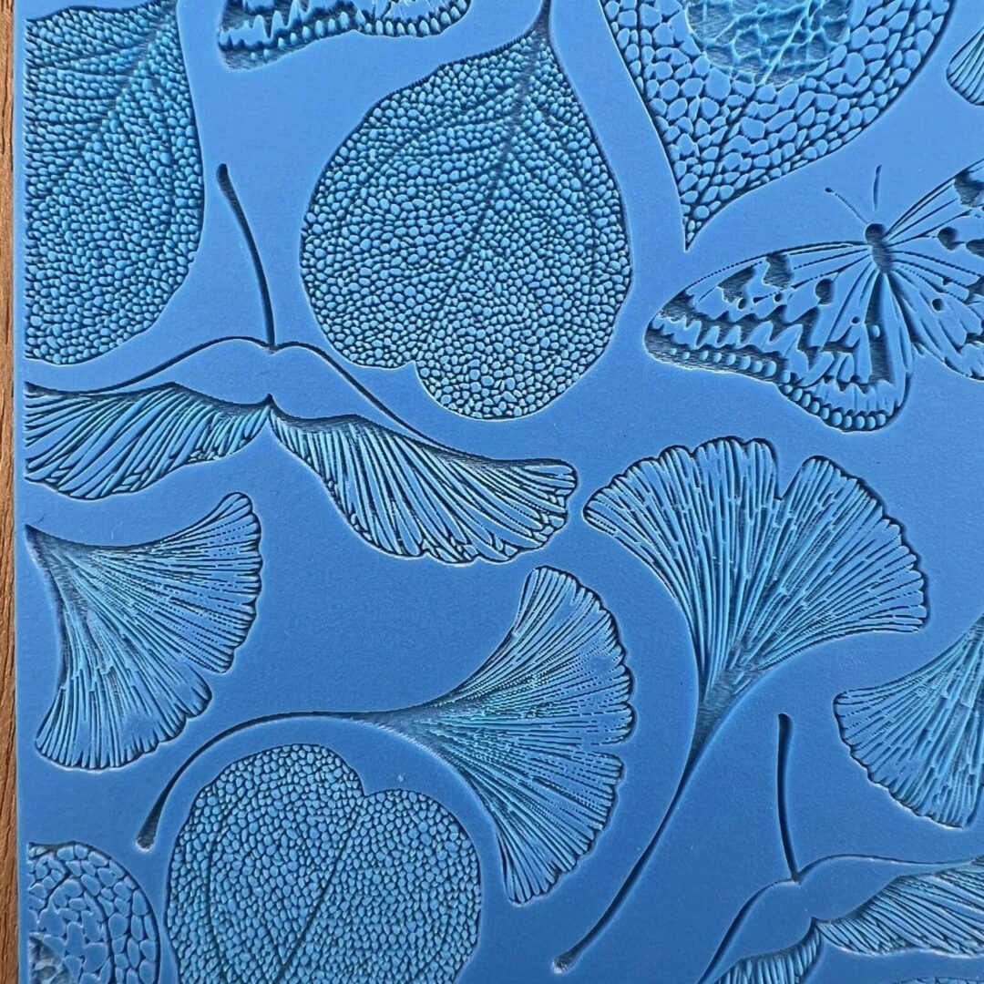 Detailed blue artwork featuring ginkgo leaves and a butterfly.