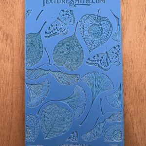 Illustrated blue book cover featuring detailed leaf drawings.