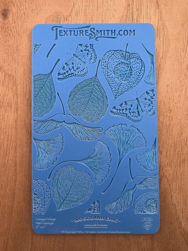 Illustrated blue book cover featuring detailed leaf drawings.