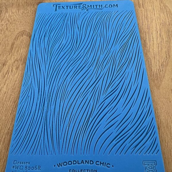 Blue textured stencil sheet with a wavy pattern from Woodland Scenics.