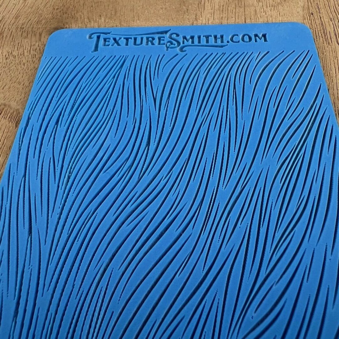 Blue textured silicone mat with wavy line patterns.