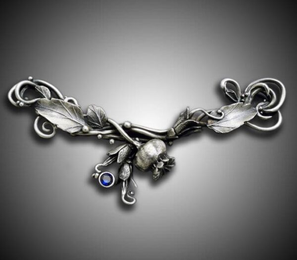 Intricate silver necklace with detailed feather and eye charms.