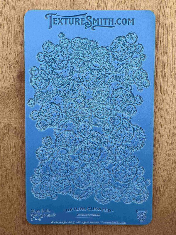 Intricate floral pattern embossed on a blue surface.