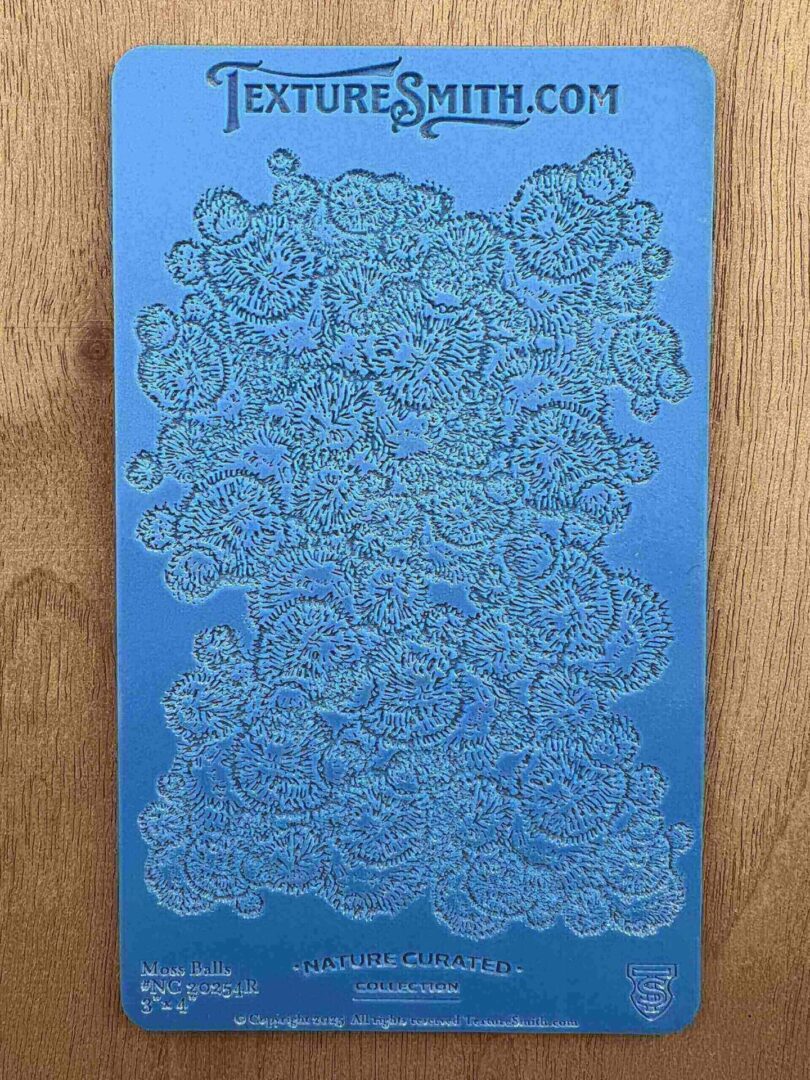 Intricate floral pattern embossed on a blue surface.