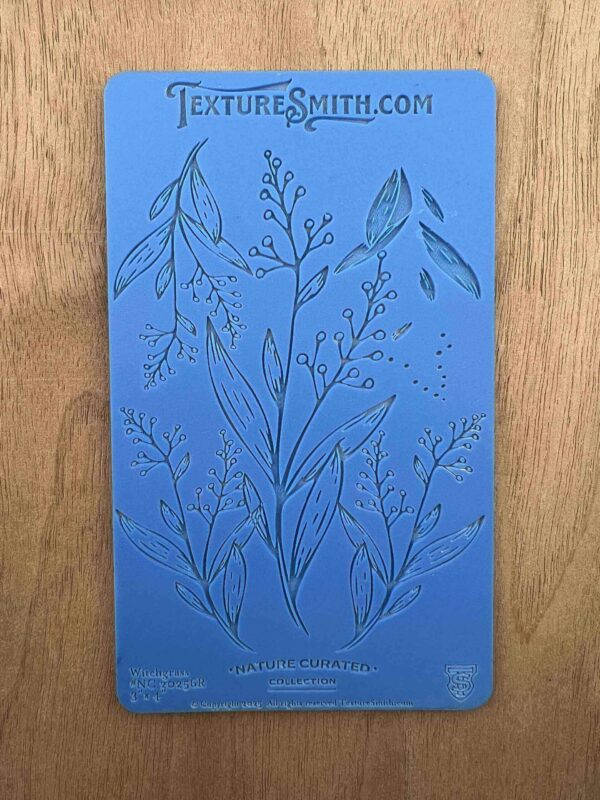 A blue card with botanical illustrations of various plants and herbs.