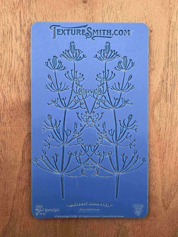 A blue bookmark with an intricate floral design and text at the top.