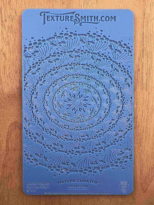 Blue card with concentric circle patterns made from small black dots.