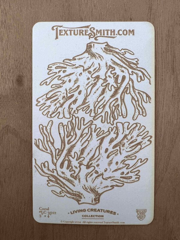 Intricate wooden coral cutouts on a wooden background.
