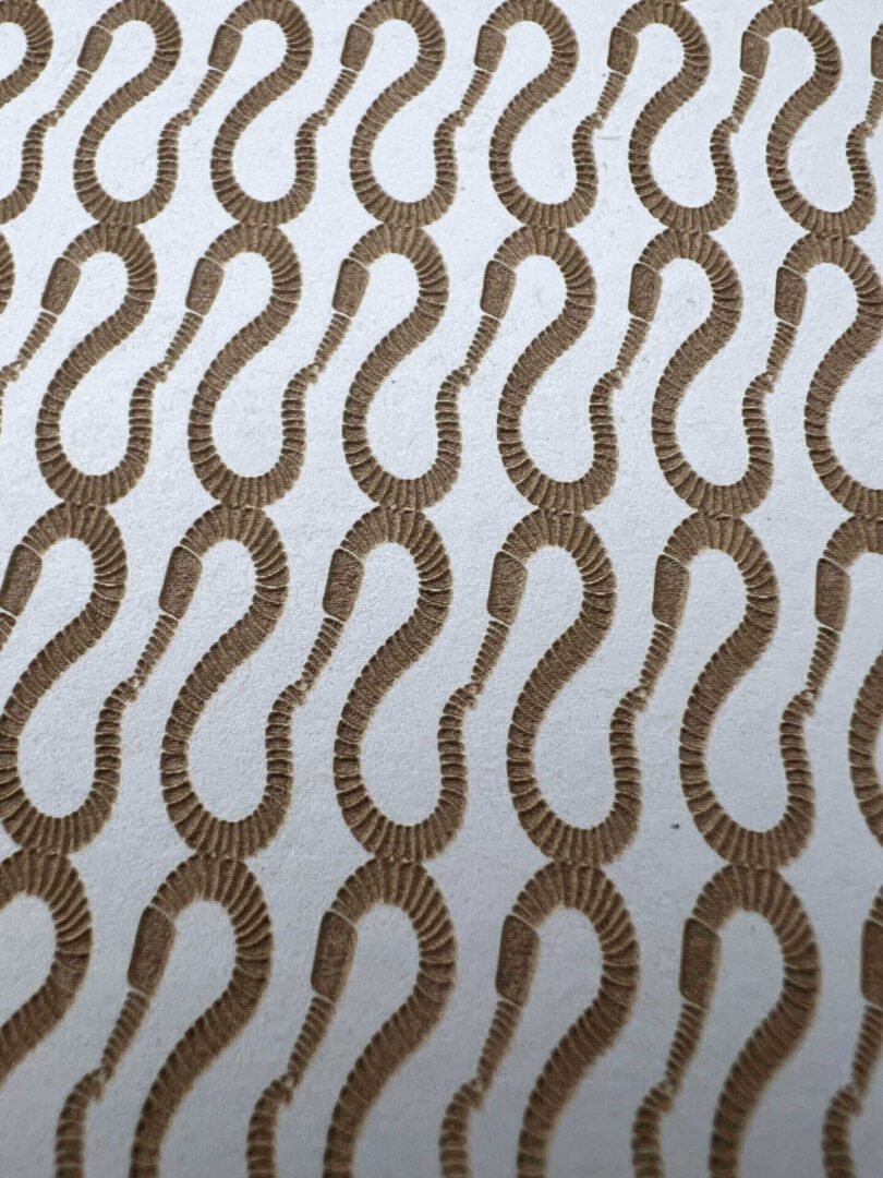 Brown question mark patterns on a white fabric background.