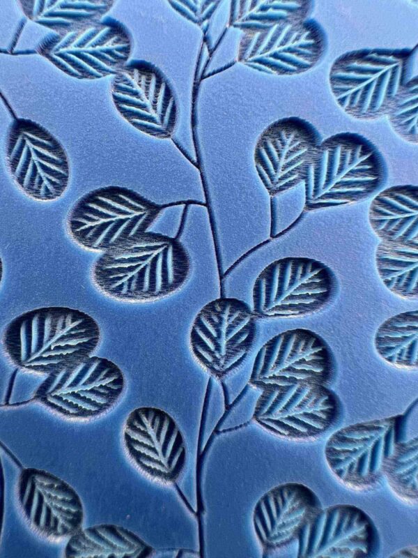 Blue fabric with embossed leaf patterns.