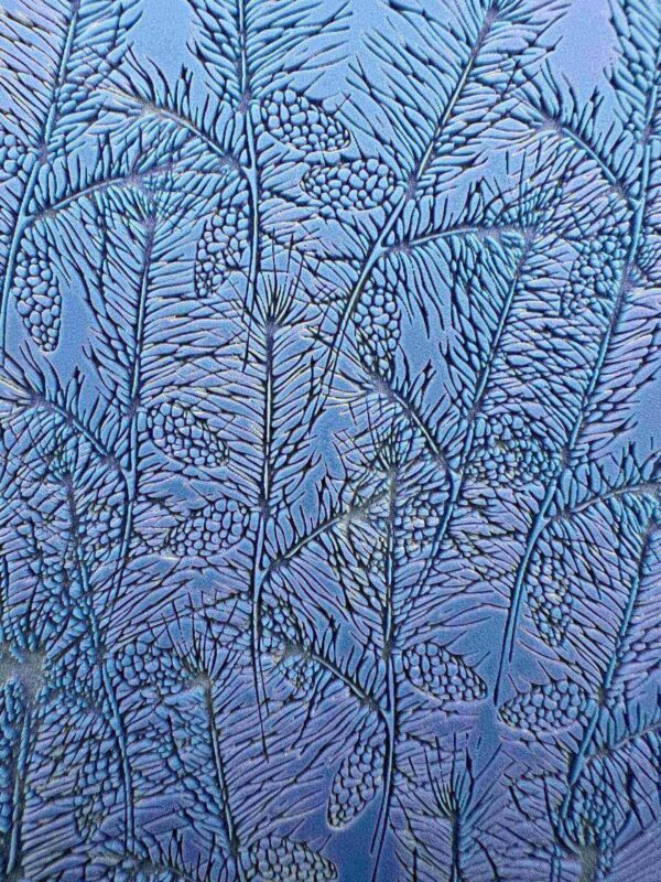 Intricate frost patterns resembling delicate leaves on a window.