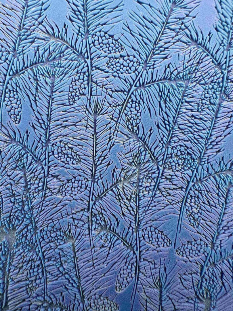 Intricate frost patterns resembling delicate leaves on a window.