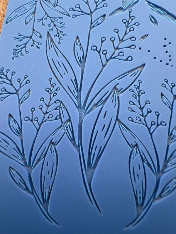 Delicate line art of leafy branches on a blue background.