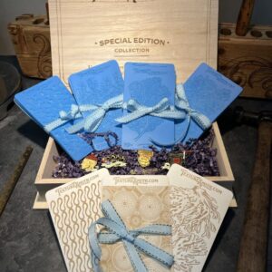 Gift box with blue pouches and decorative cards tied with ribbons.