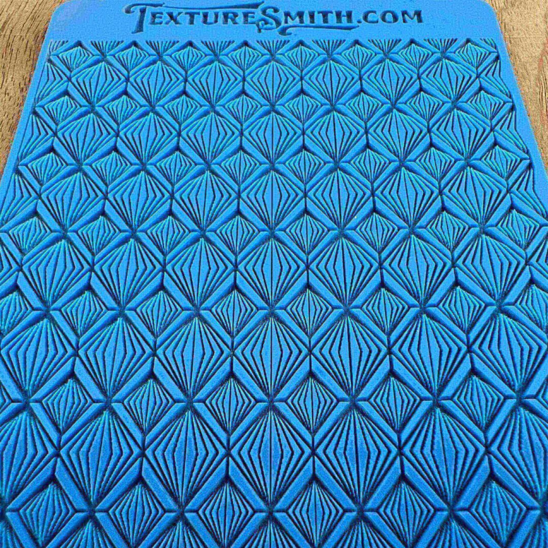Blue textured surface with geometric diamond patterns.