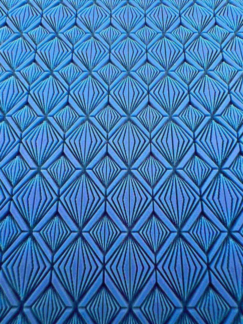 Blue geometric pattern with symmetrical diamond shapes.