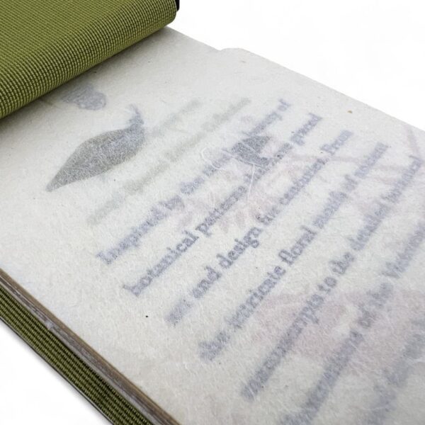 A book page with translucent protective paper partially covering printed text and an illustration.