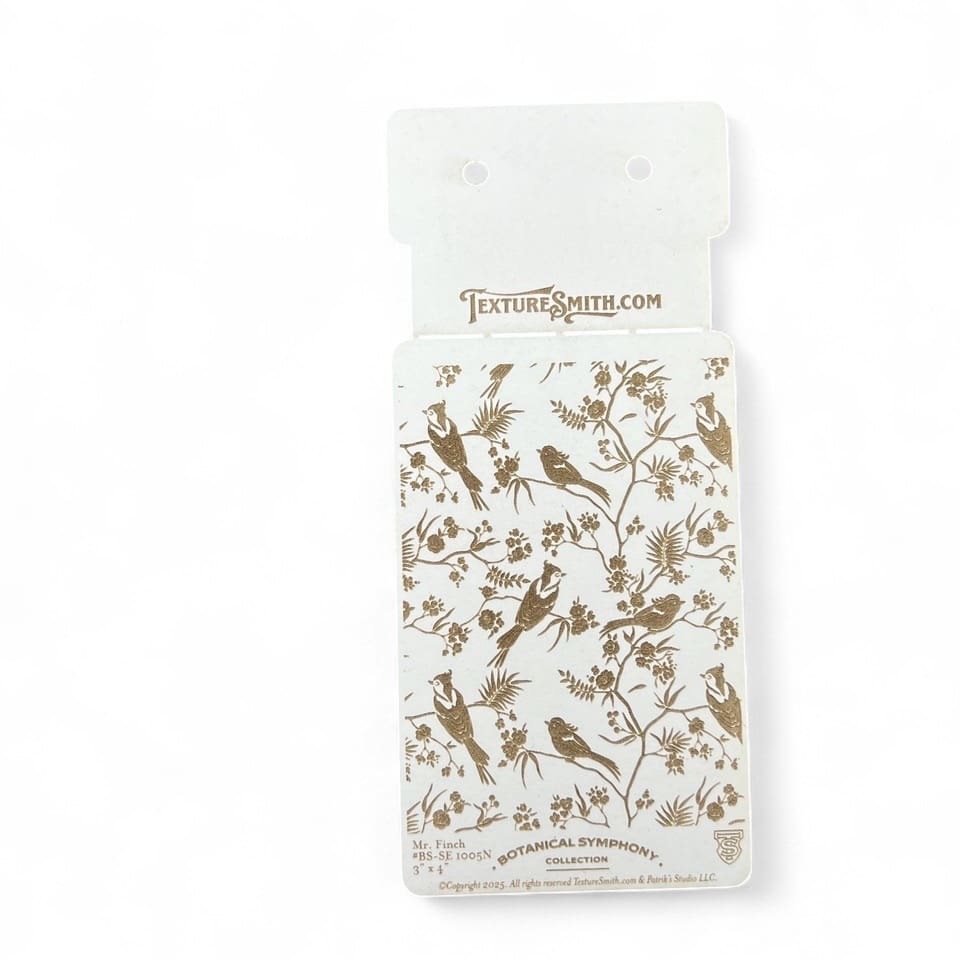 Clear phone case with gold floral design inside packaging.
