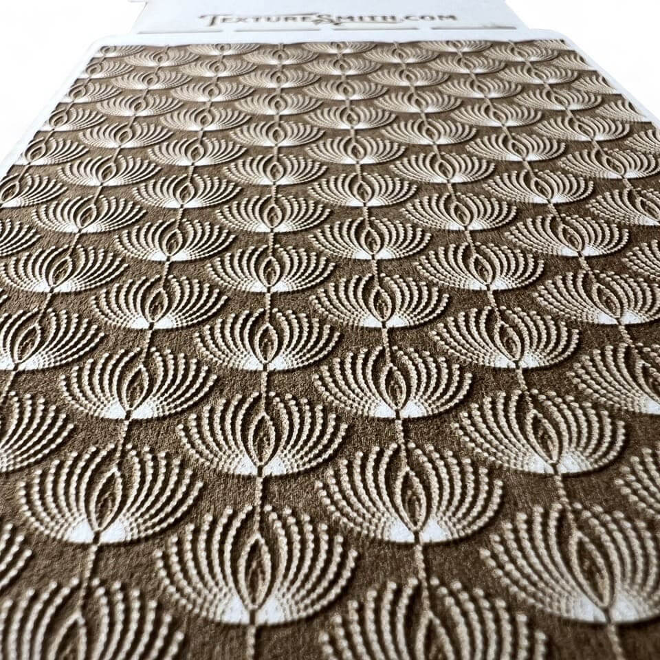 Intricate textured pattern with concentric circles and fan shapes.