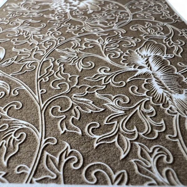 Close-up of an embossed floral pattern on a textured surface.